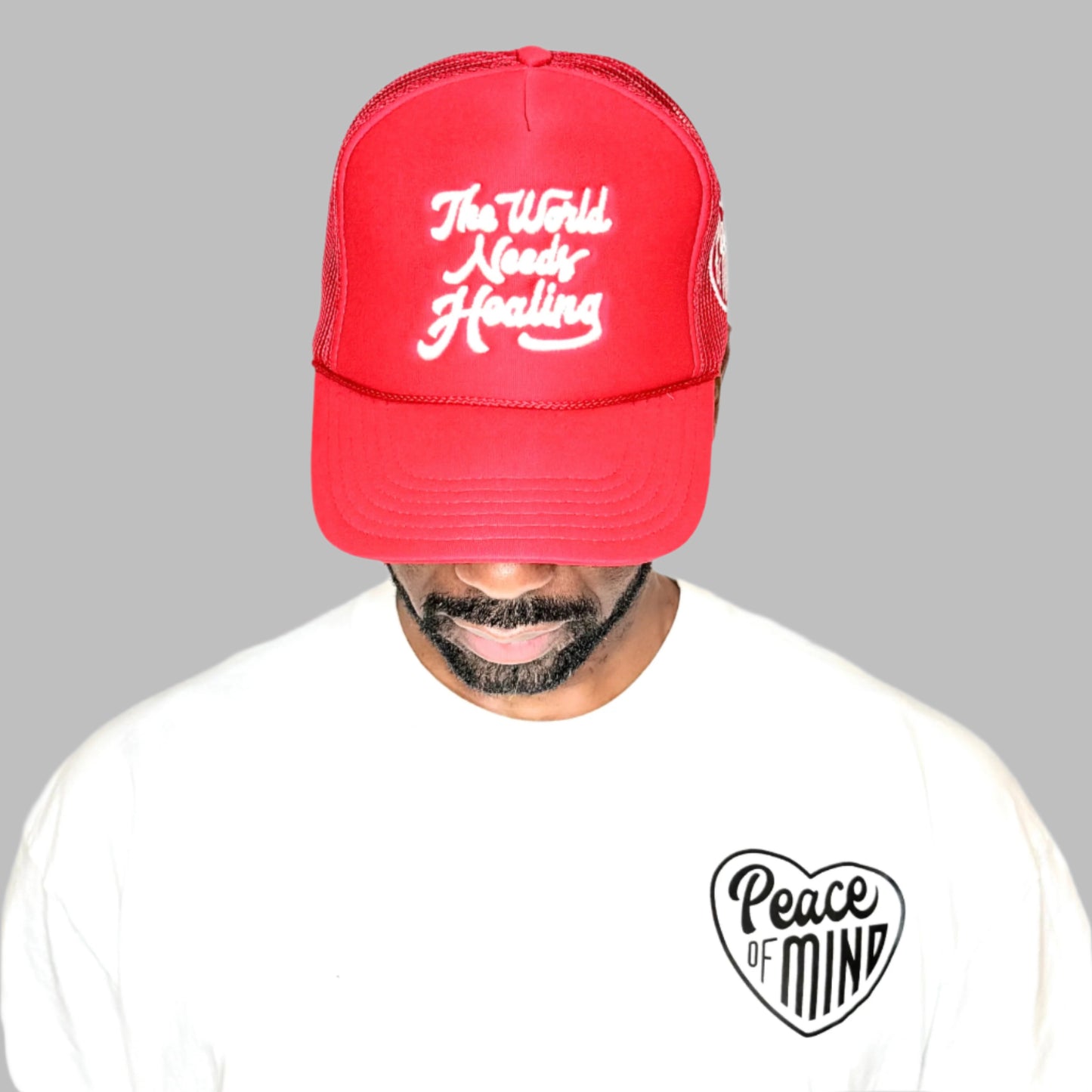 World Needs Healing Trucker Hat Red