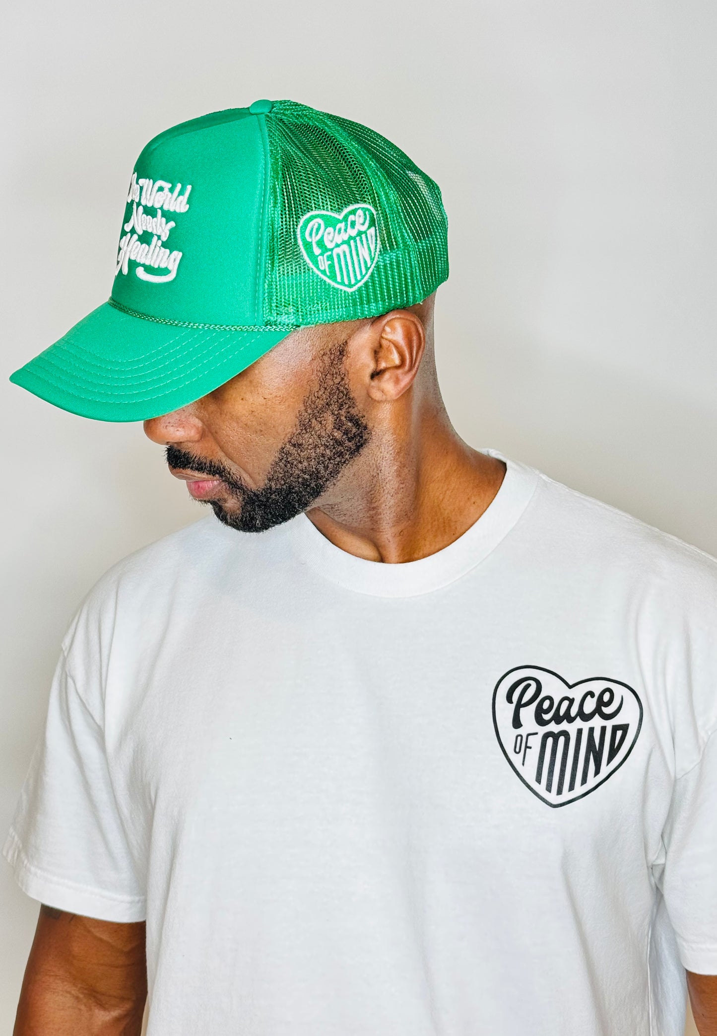 World Needs Healing Trucker Hat Kelly Green