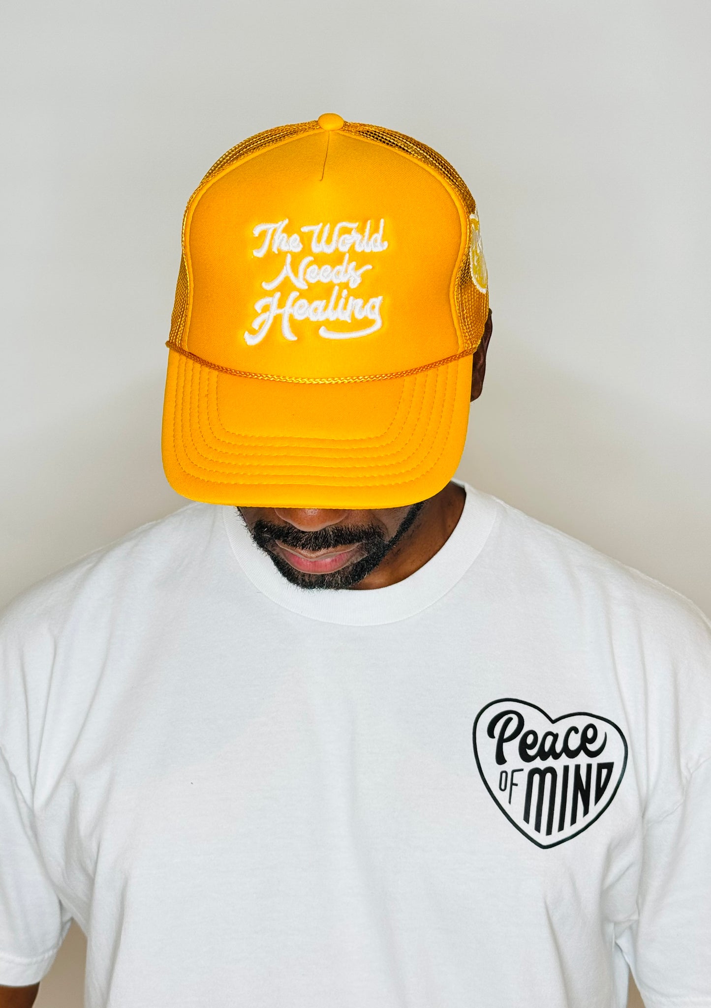 World Needs Healing Trucker HatYellow