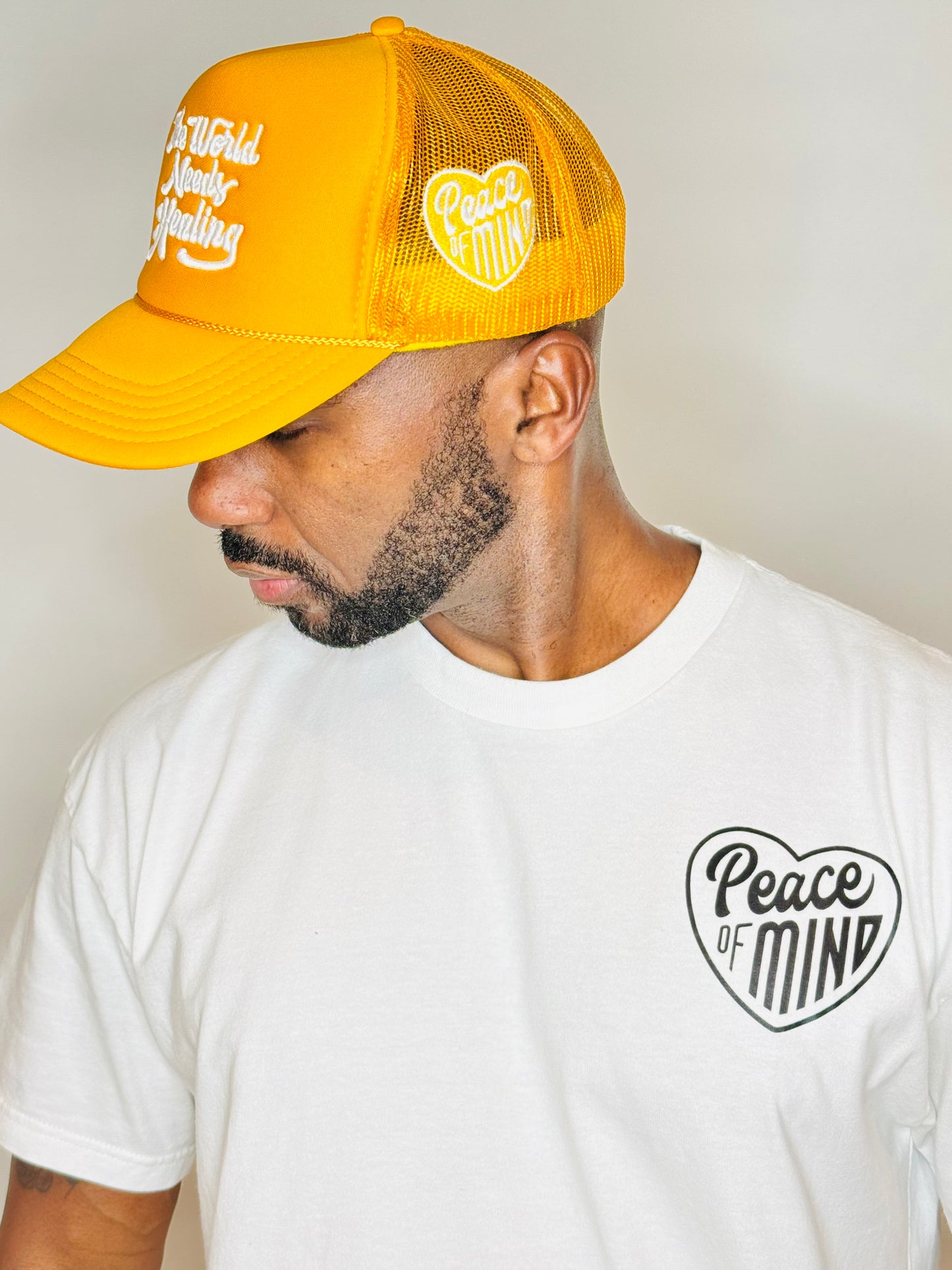 World Needs Healing Trucker HatYellow