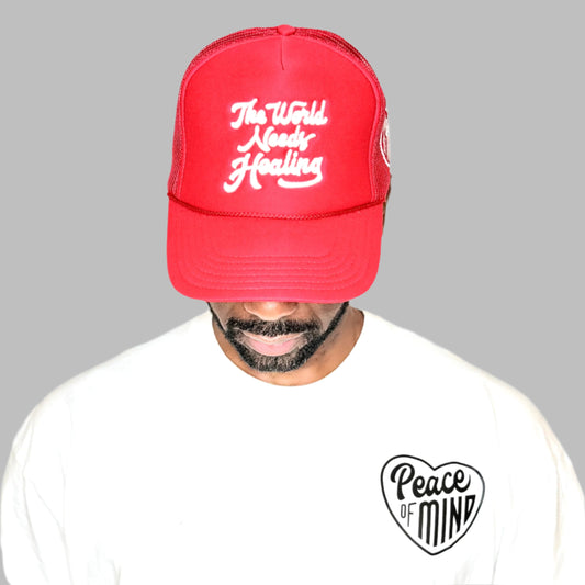 World Needs Healing Trucker Hat Red