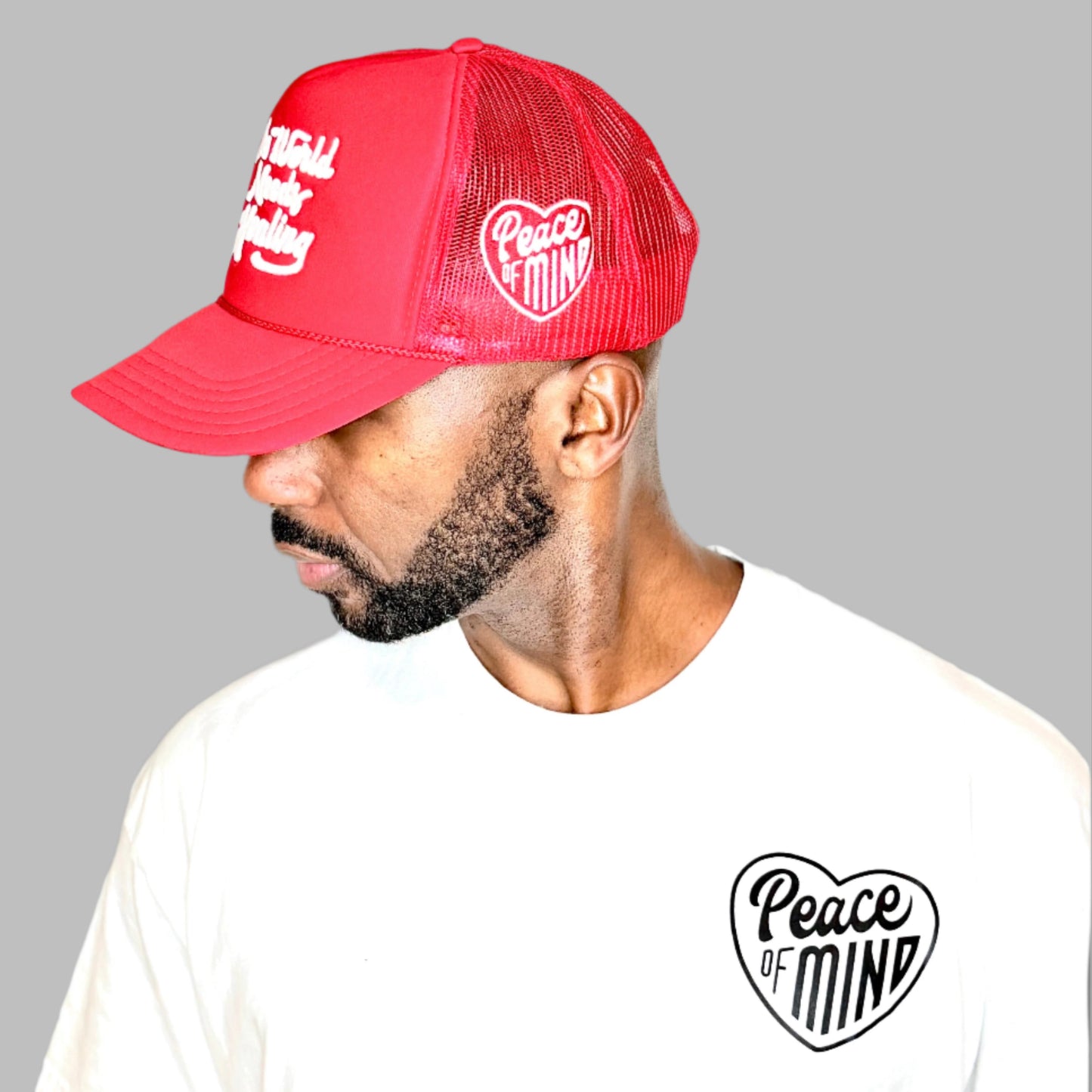 World Needs Healing Trucker Hat Red
