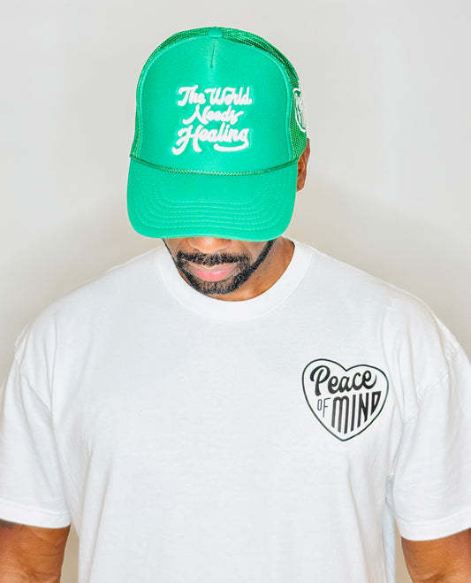 World Needs Healing Trucker Hat Kelly Green