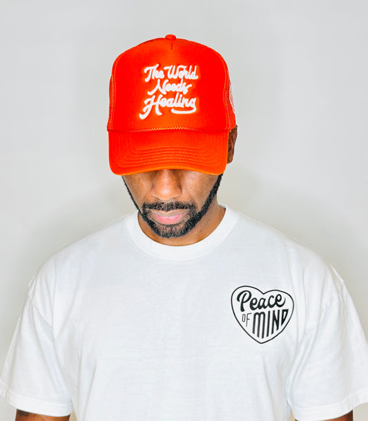 World Needs Healing Trucker Hat Orange
