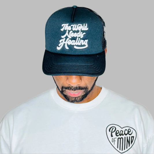 World Needs Healing Trucker Hat Black